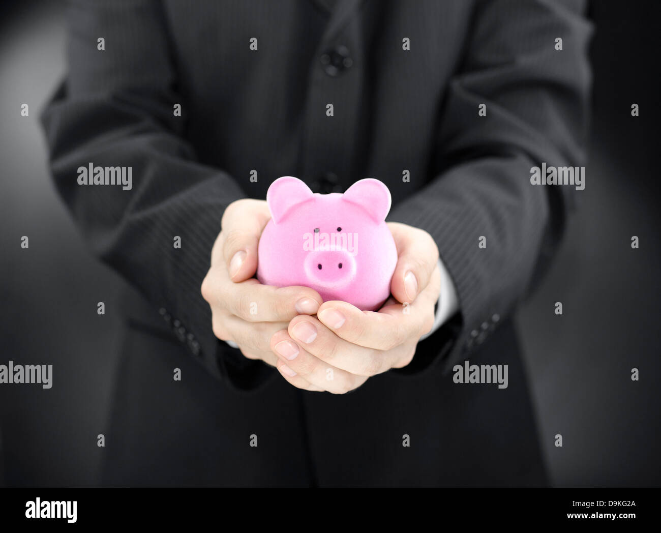 Man holding piggy bank Stock Photo - Alamy