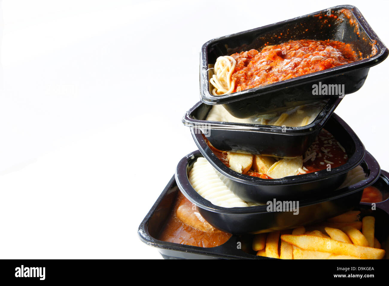 A stack of frozen ready meals on a white background. Stock Photo