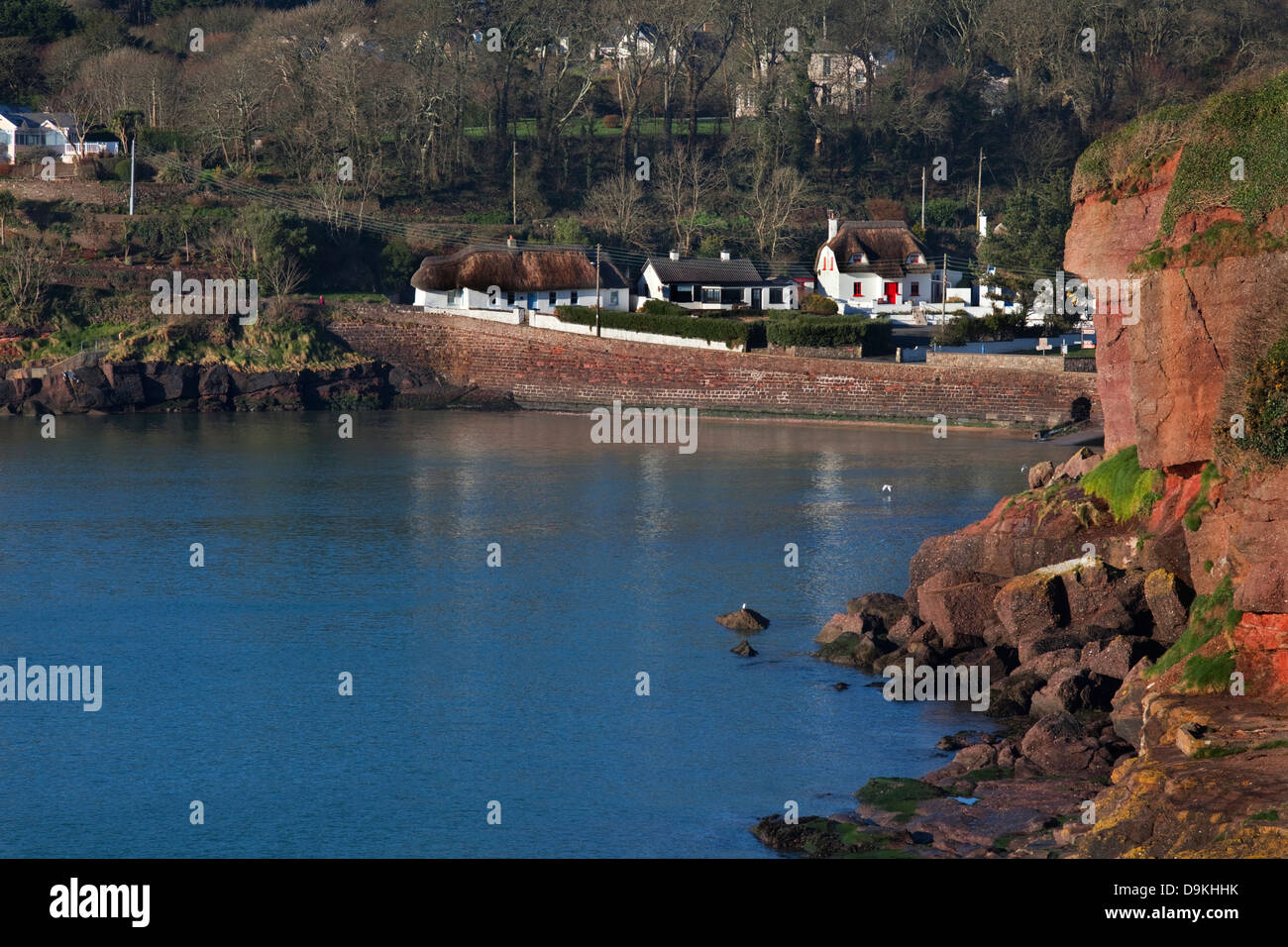 Thatched Cottages around distant Dunmore Strand, Dunmore East Fishing Port, County Waterford, Ireland Stock Photo