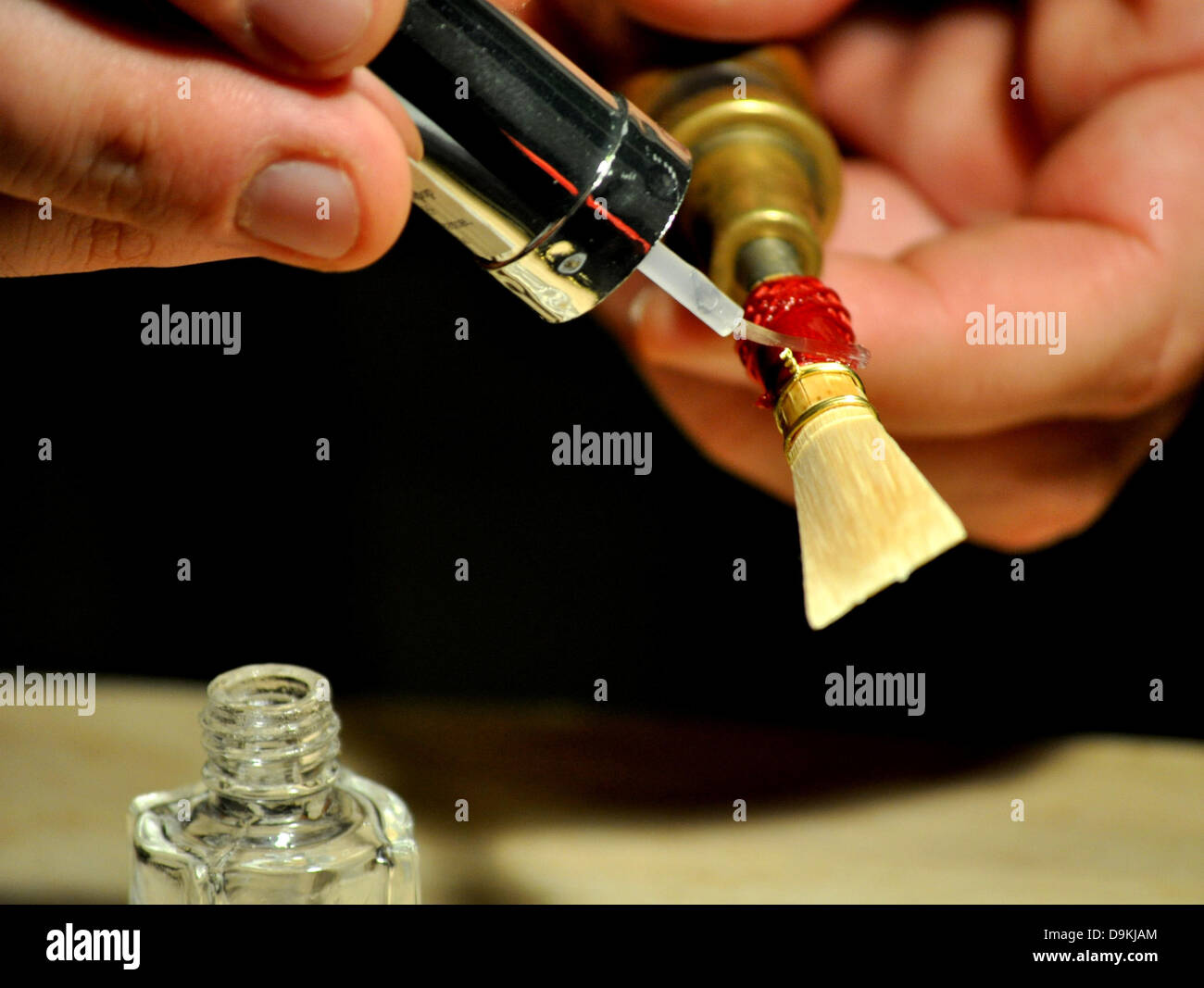 Binding the bassoon reed with red cotton thread after drying on the