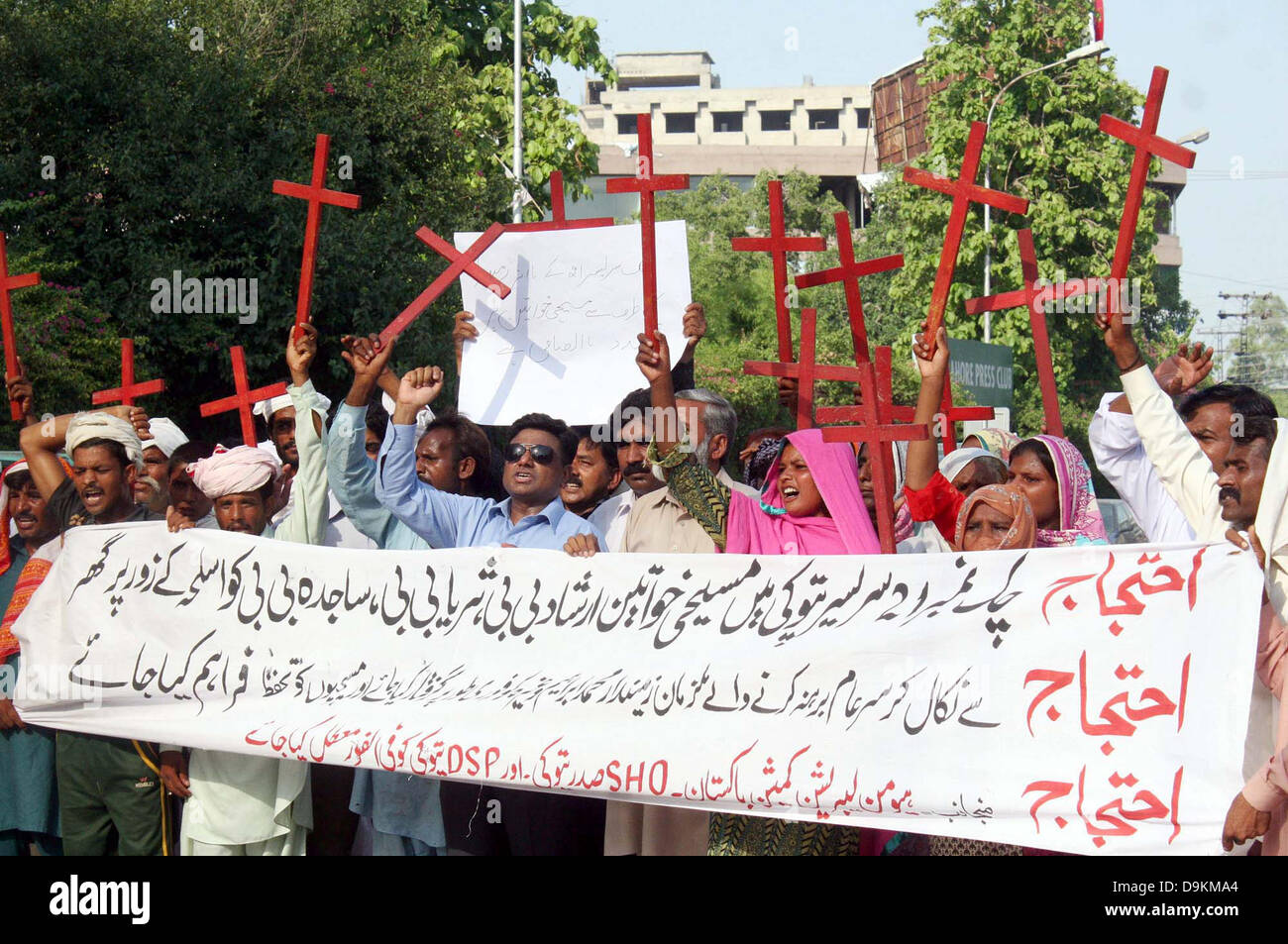 Residents of District Kasur Sadar Pattoki area chant slogans against high- handedness of their area police officials during protest demonstration arranged by Human Liberation Commission at Lahore press club on Friday, June 21, 2013. Stock Photo