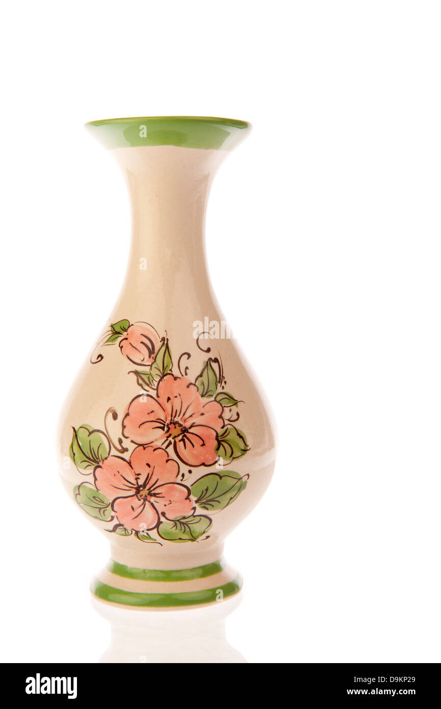 A single decorated vase with pink flowers and green leaves isolated on white Stock Photo