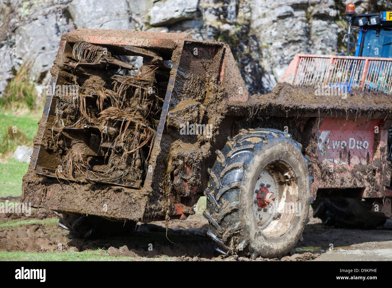 A farmer spreading cow muck on a field in Buttermere, Lake District, UK Stock Photo Alamy