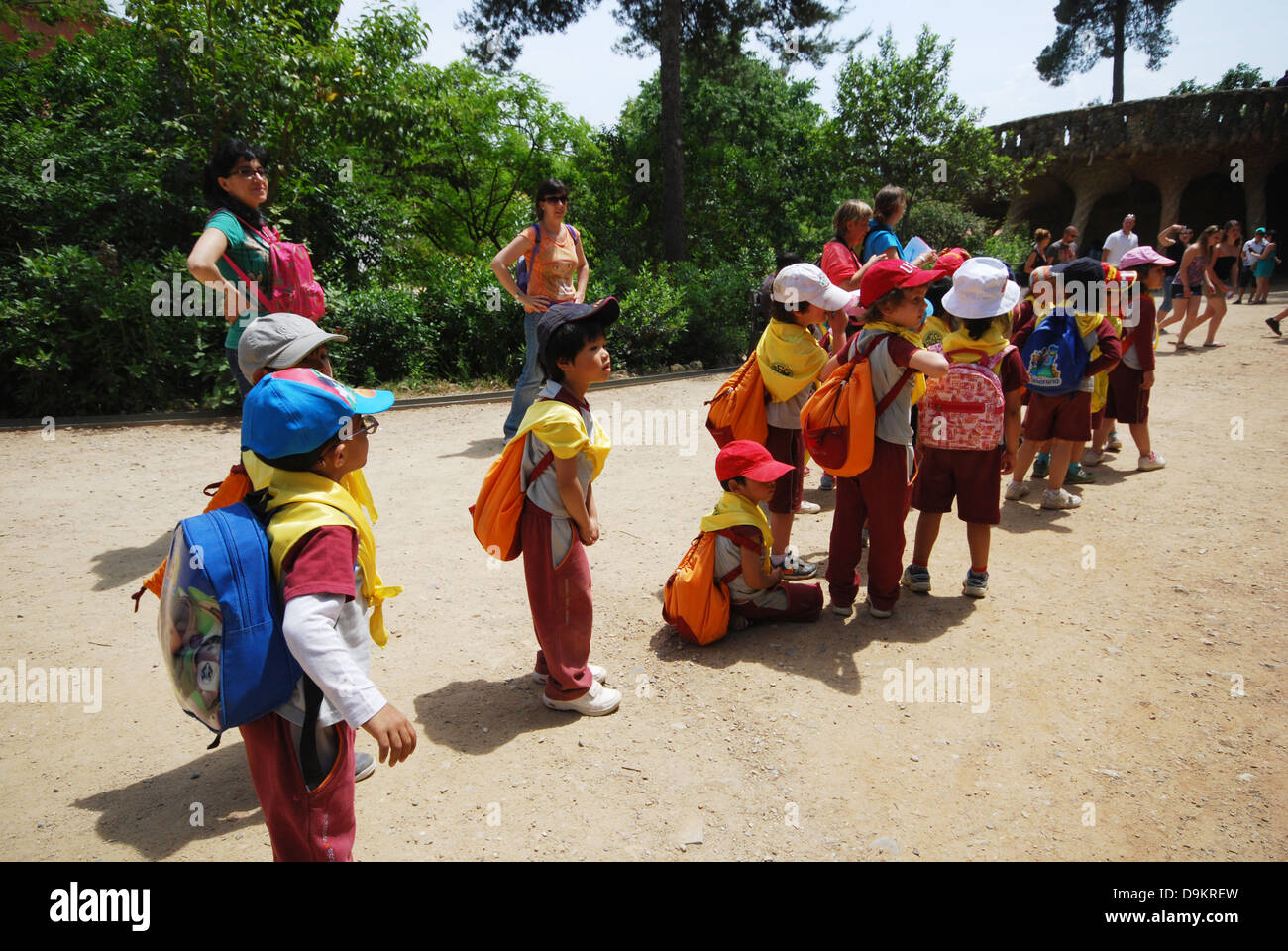 group of infants and their companions on their way to Parc Guell Barcelona Spain Stock Photo