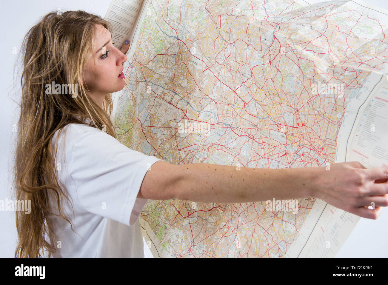 A young woman with long blonde hair looking confused at an Ordnance Survey  map of west London UK Stock Photo - Alamy