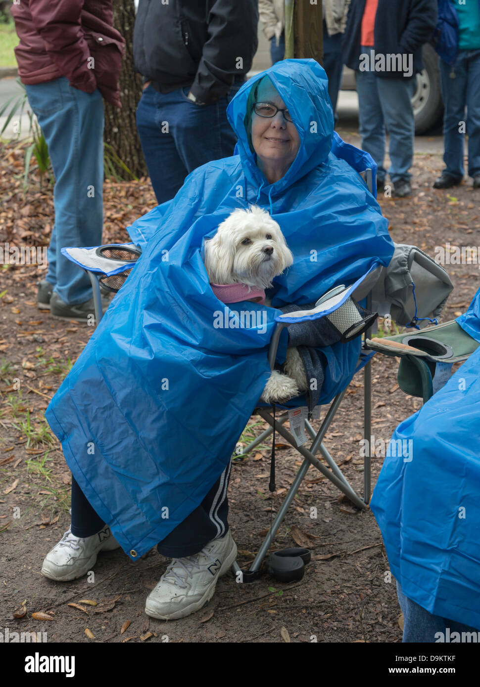 Woman protecting her dog from the rain at outdoor concert at Manatee Springs State Park along the Suwannee River in North FL. Stock Photo