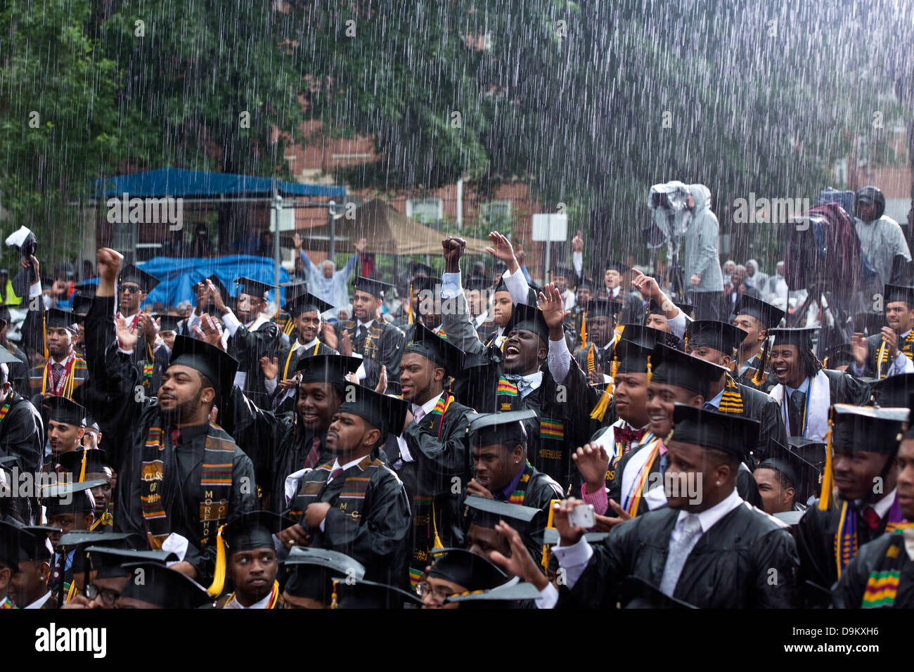 Graduates react as President Barack Obama delivers remarks during the commencement ceremony in pouring rain at Morehouse College May 19, 2013 in Atlanta, GA. Stock Photo