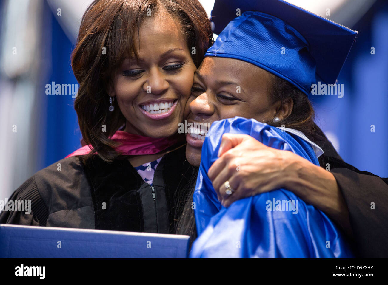 US First Lady Michelle Obama hands a diploma to a graduating senior during the Martin Luther King, Jr. Academic Magnet High School for Health Sciences and Engineering at Historic Pearl High commencement ceremony May 18, 2013 in Nashville, TN. Stock Photo