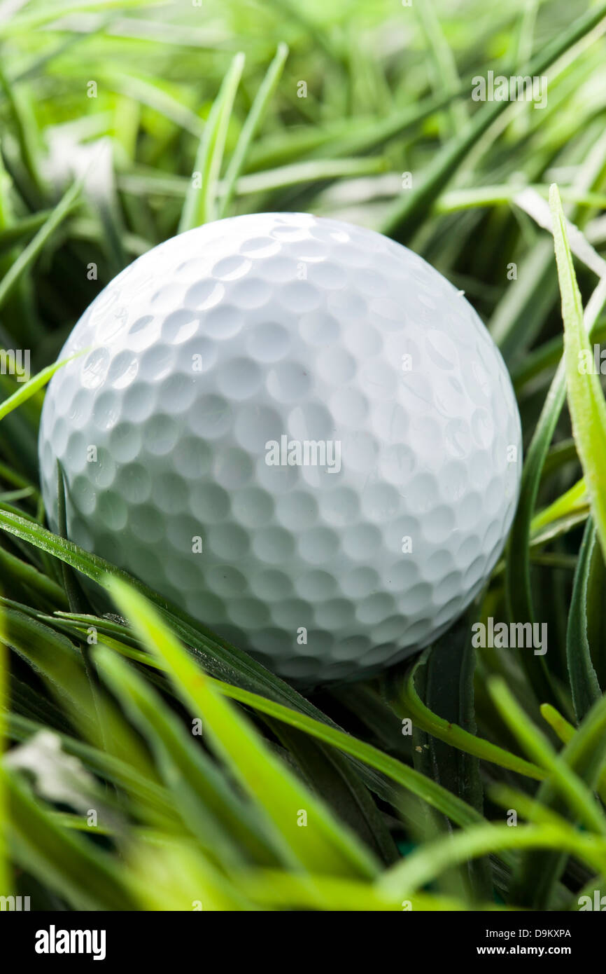 Pure White Golfball on bright green grass Stock Photo