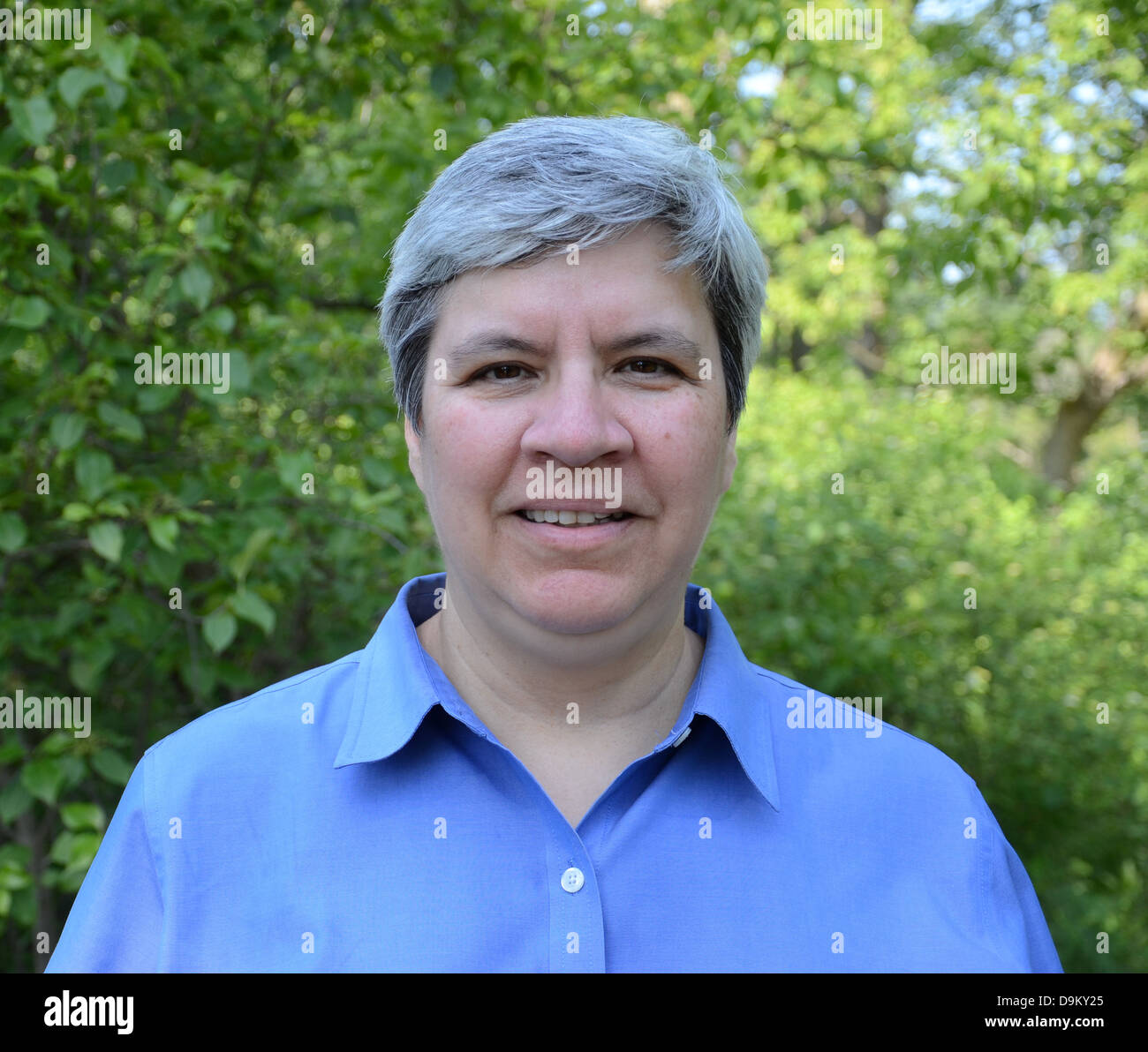 Middle aged woman looking directly at camera, in garden Stock Photo Alamy