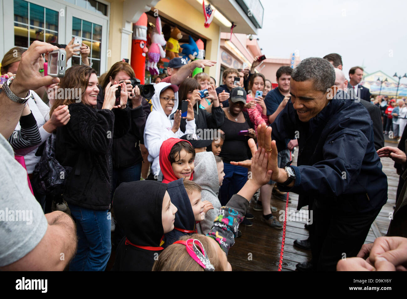 US President Barack Obama high-fives kids during a visit to the Point Pleasant boardwalk May 28, 2013 in Point Pleasant Beach, NJ. Stock Photo