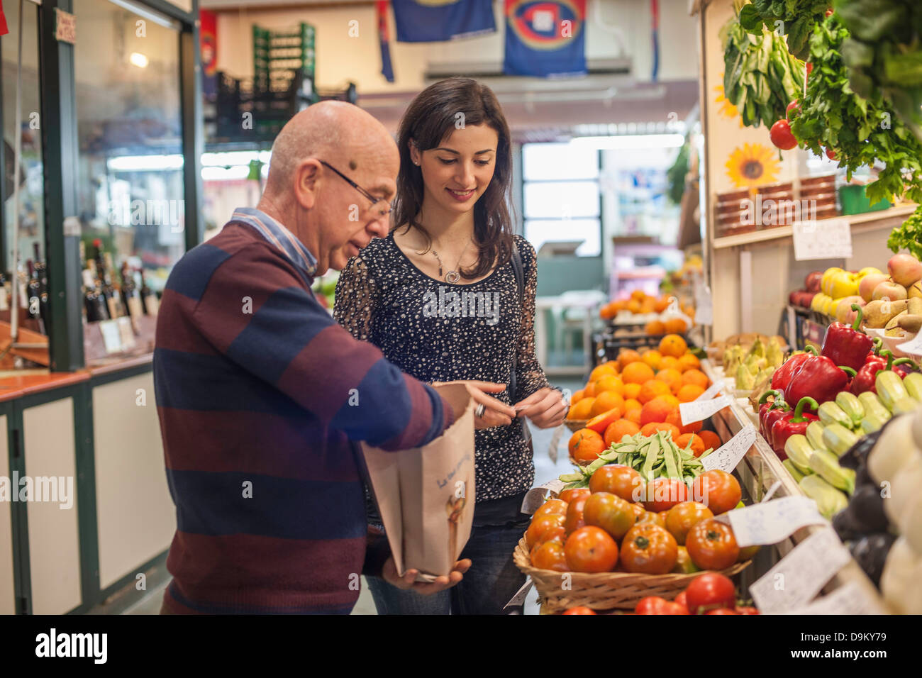 Female customer with shopkeeper in market Stock Photo Alamy