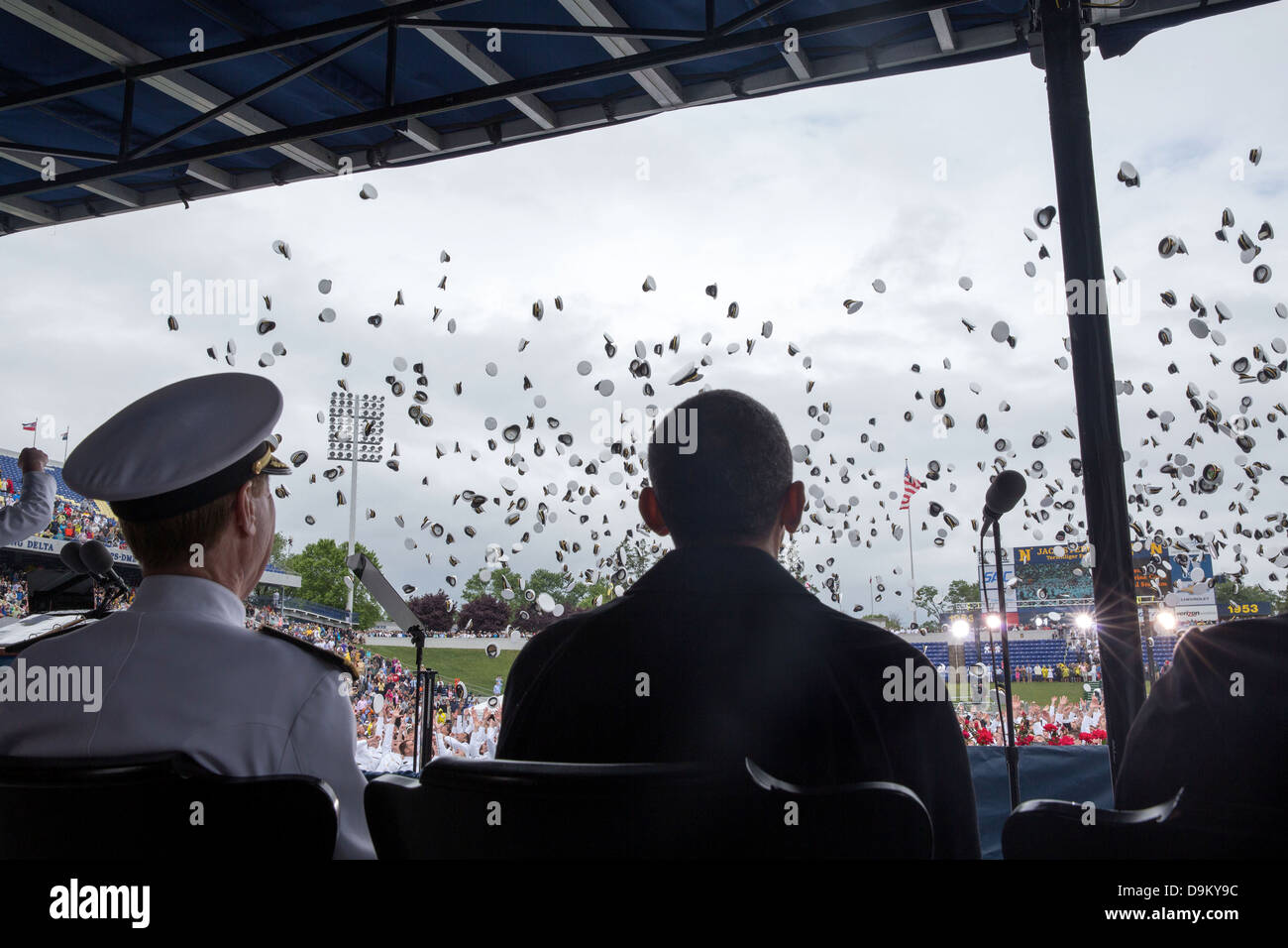 US President Barack Obama watches as graduates toss their hats at the conclusion of the US Naval Academy commencement at the Navy-Marine Corps Memorial Stadium May 24, 2013 in Annapolis, MD. Stock Photo