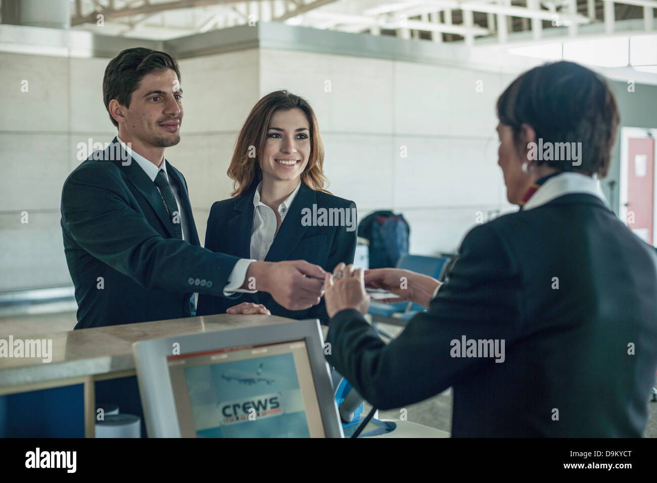 Businesspeople at airport check in area Stock Photo