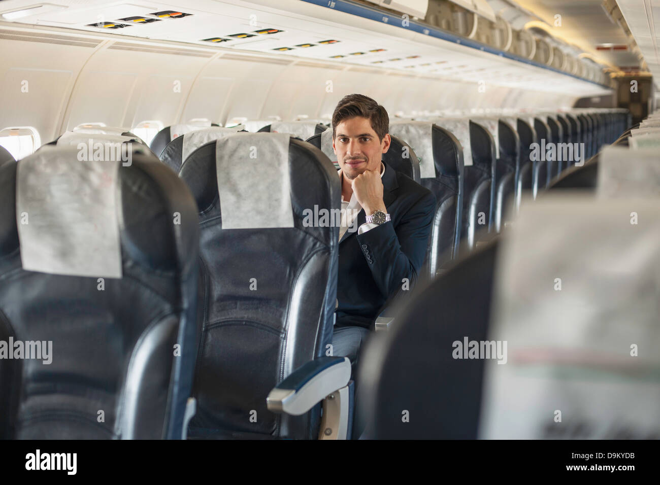 Male passenger sitting on aeroplane Stock Photo