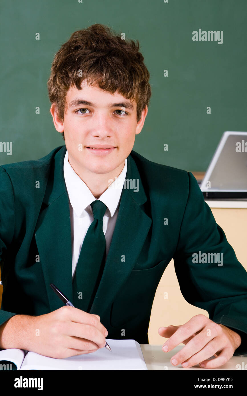 cute high school boy in classroom Stock Photo