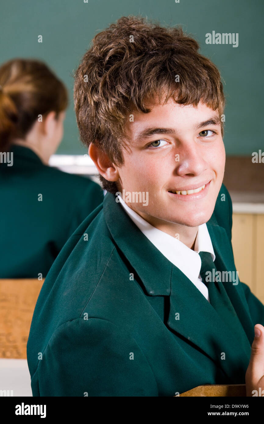 cute high school boy and classmate in classroom Stock Photo