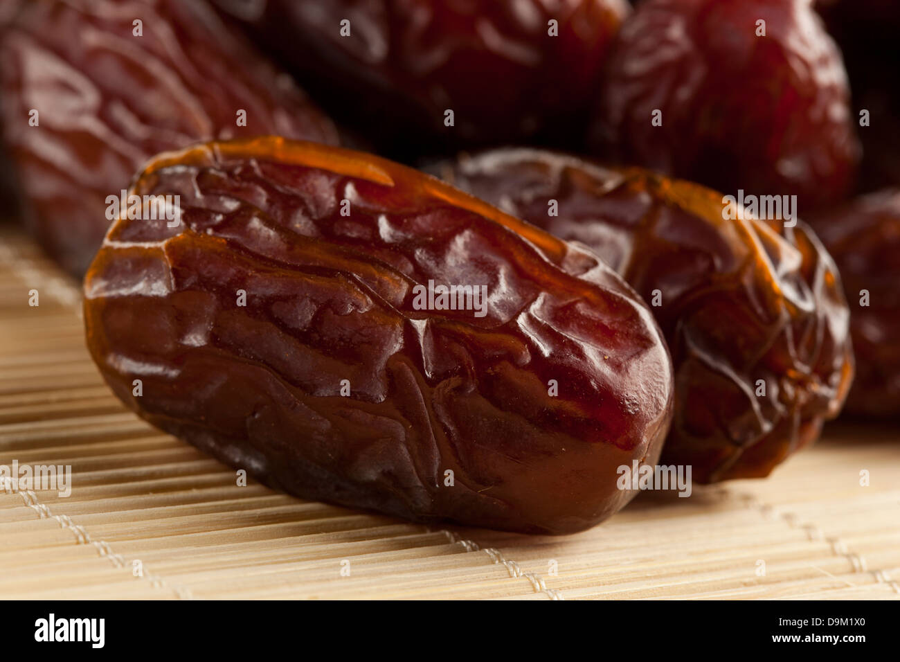 Fresh Organic Raw Brown Date Fruit against a background Stock Photo