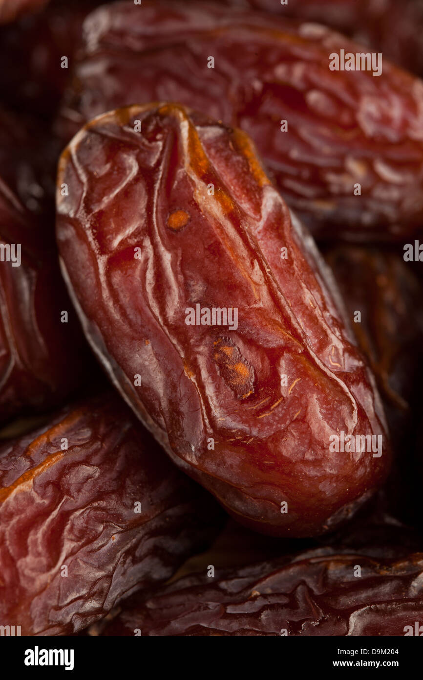 Fresh Organic Raw Brown Date Fruit against a background Stock Photo
