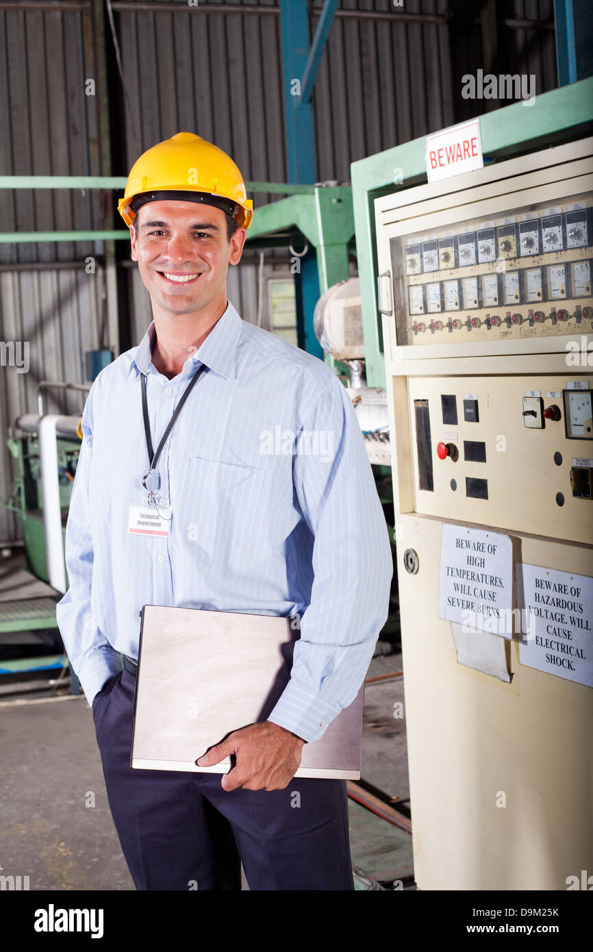 happy male industrial technician inside a factory Stock Photo