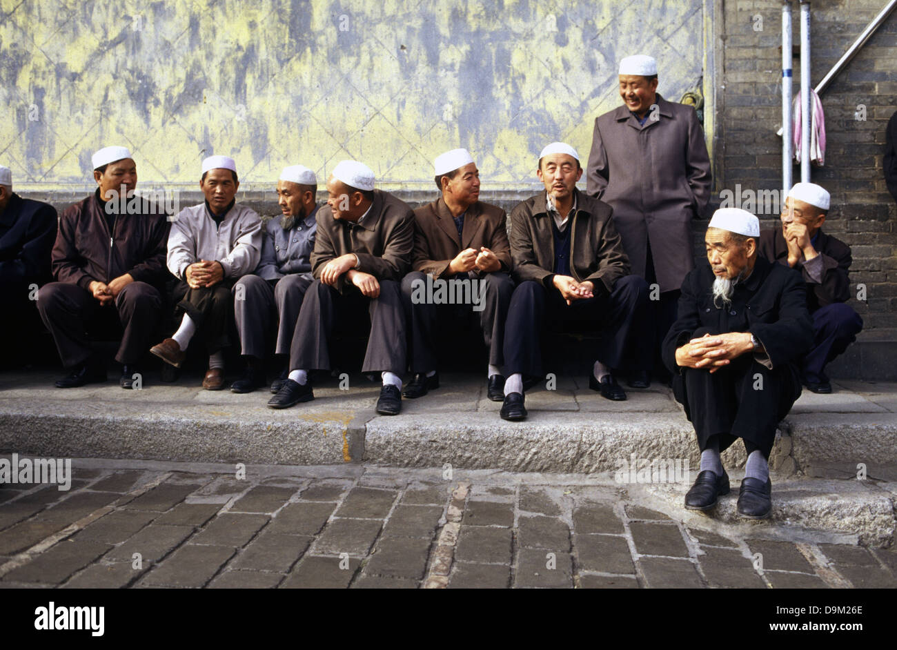 Hui Muslims men in the courtyard of Dongguan Grand Mosque originally built in 1380 in Xining the capital of Qinghai province in western China Stock Photo