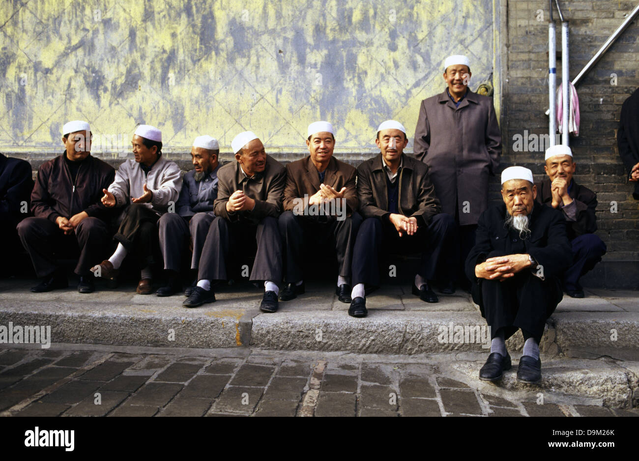 Hui Muslims men in the courtyard of Dongguan Grand Mosque originally built in 1380 in Xining the capital of Qinghai province in western China Stock Photo