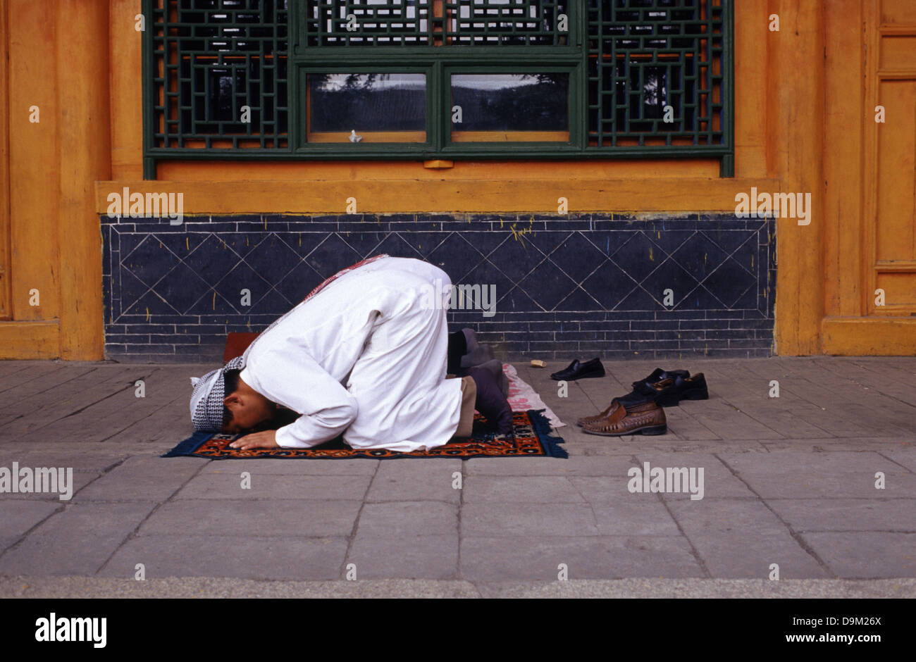 Hui Muslims worshipers praying at the courtyard of Dongguan Grand Mosque originally built in 1380 in Xining the capital of Qinghai province in western China Stock Photo