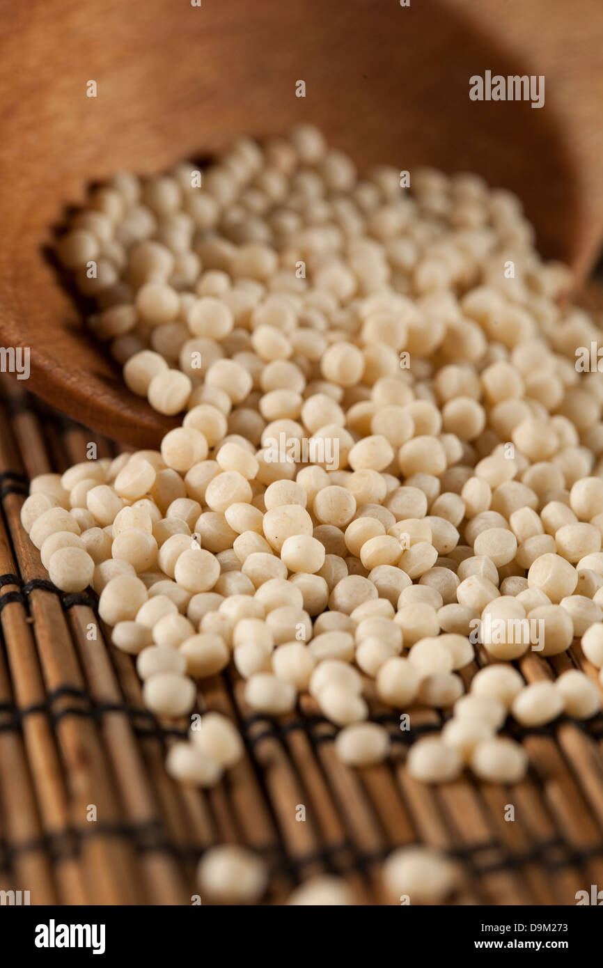 Organic Raw Middle Eastern Couscous against a background Stock Photo