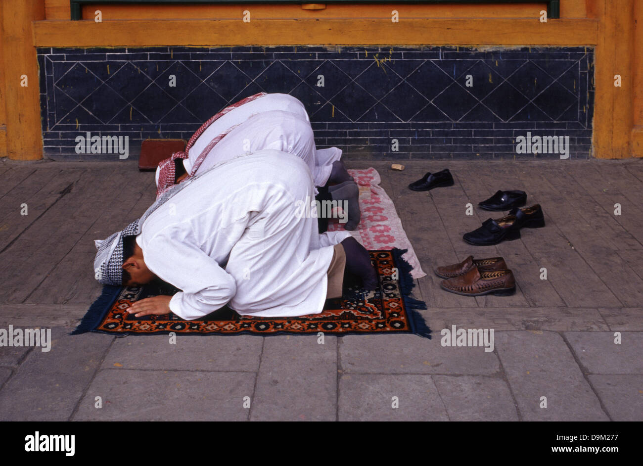 Hui Muslims worshipers praying at the courtyard of Dongguan Grand Mosque originally built in 1380 in Xining the capital of Qinghai province in western China Stock Photo