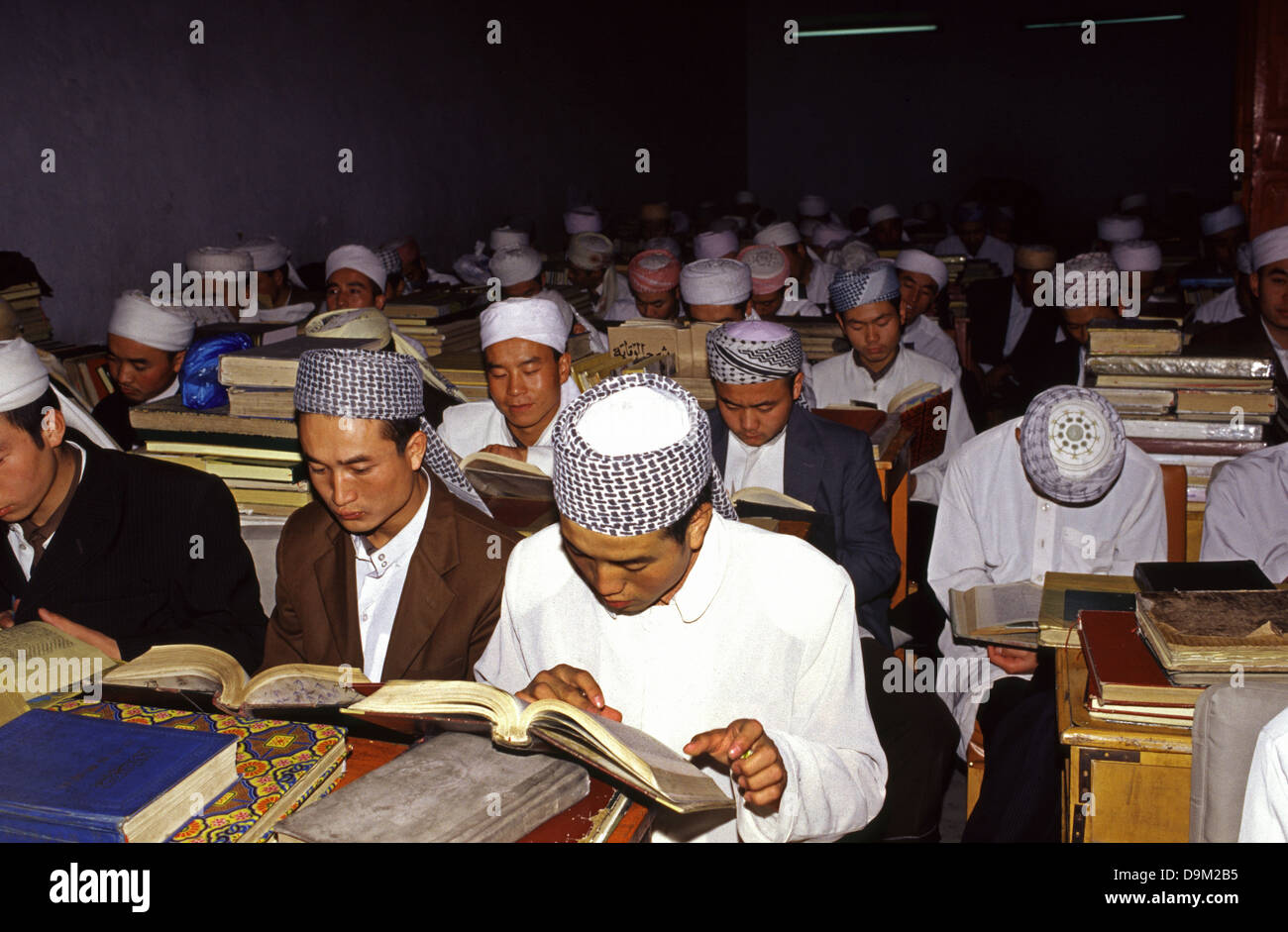 Hui Muslim men studying the Quran at madrassa classroom in Dongguan Grand Mosque in Xining the capital of Qinghai province in western China Stock Photo