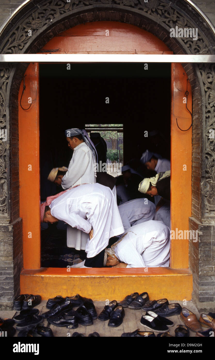 Hui Muslims worshipers praying inside Dongguan Grand Mosque originally built in 1380 in Xining the capital of Qinghai province in western China Stock Photo