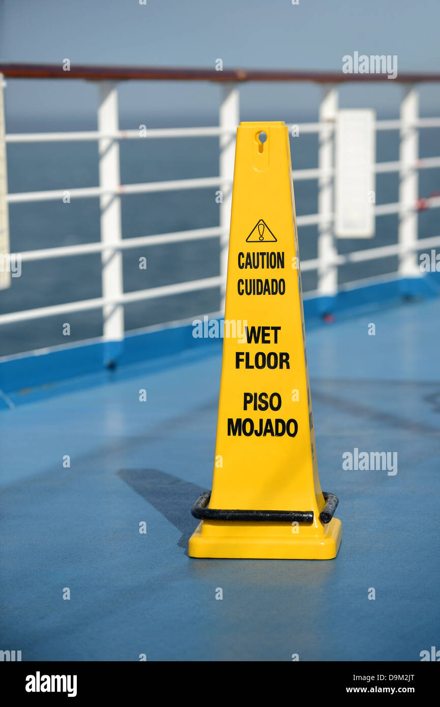 Caution Wet Floor sing on deck of cruise ship Stock Photo
