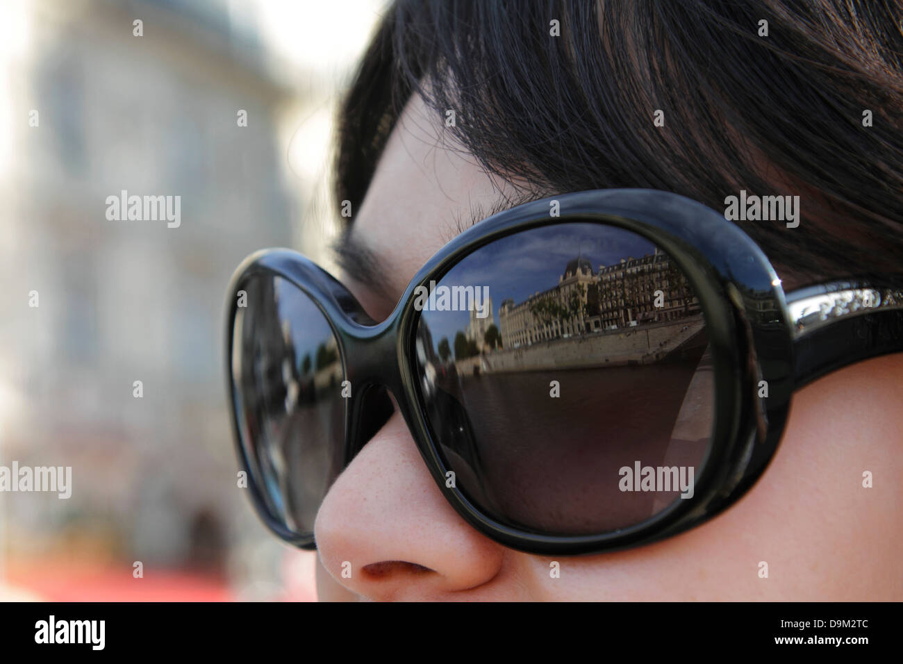 France, Paris, Notre Dame Cathedral reflected in Asian woman's Sunglasses Stock Photo