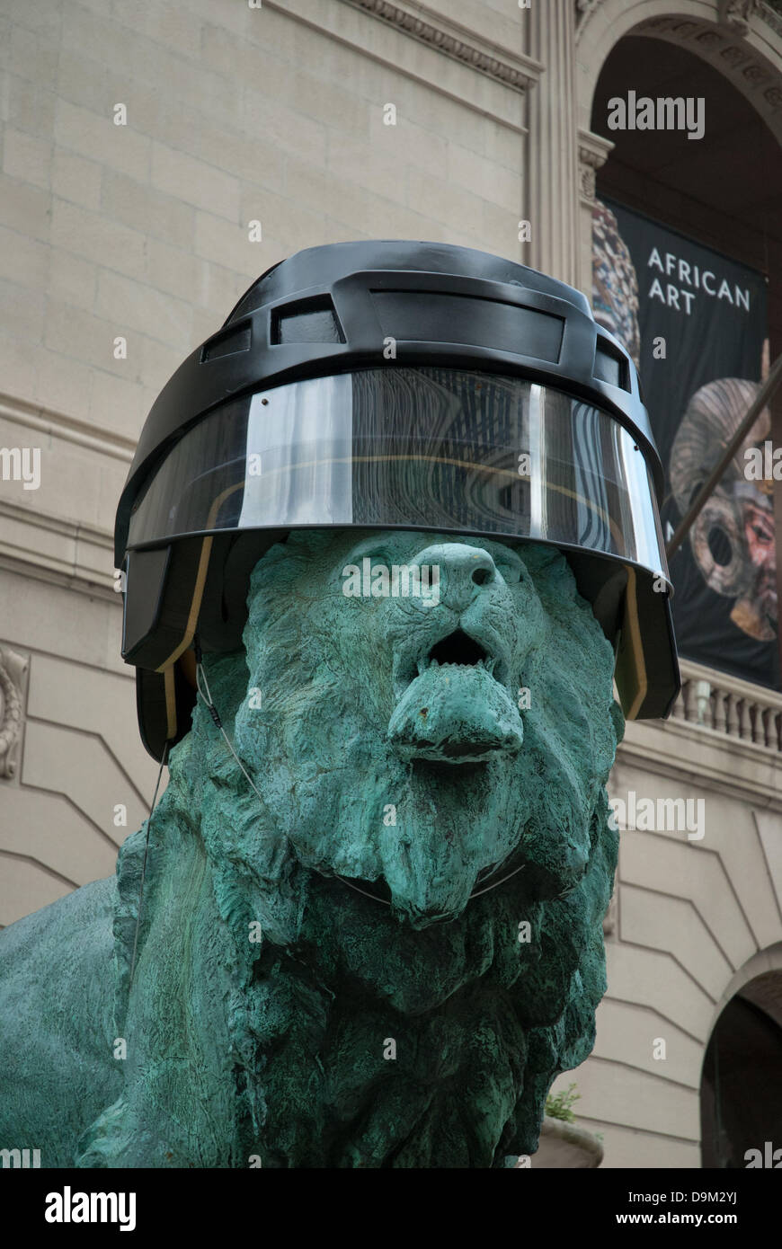 Chicago, Illinois, USA. 17th June, 2013. Art Institute of Chicago Lions wear Chicago Blackhawks' helmut as a show of support for Chicago's hockey team battling against the Boston Bruins for the Stanley Cup. The bronze statues guarding the entrance to the museum wore Hawks' helmut in 2010 when the Blackhawks brought home the Stanley Cup trophy. On other occasions, the Lions have donned White Sox hats and Chicago Bears helmets to honor Chicago's winning teams. ©Karen I. Hirsch/ZUMAPRESS.com/Alamy Live News Stock Photo