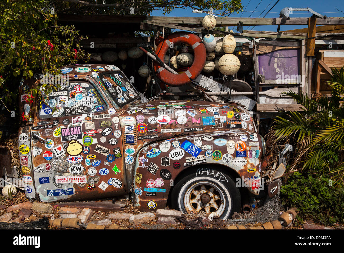 Old Rusted Truck Covered in Stickers, B.O.'s Restaurant, Key West, Florida Stock Photo