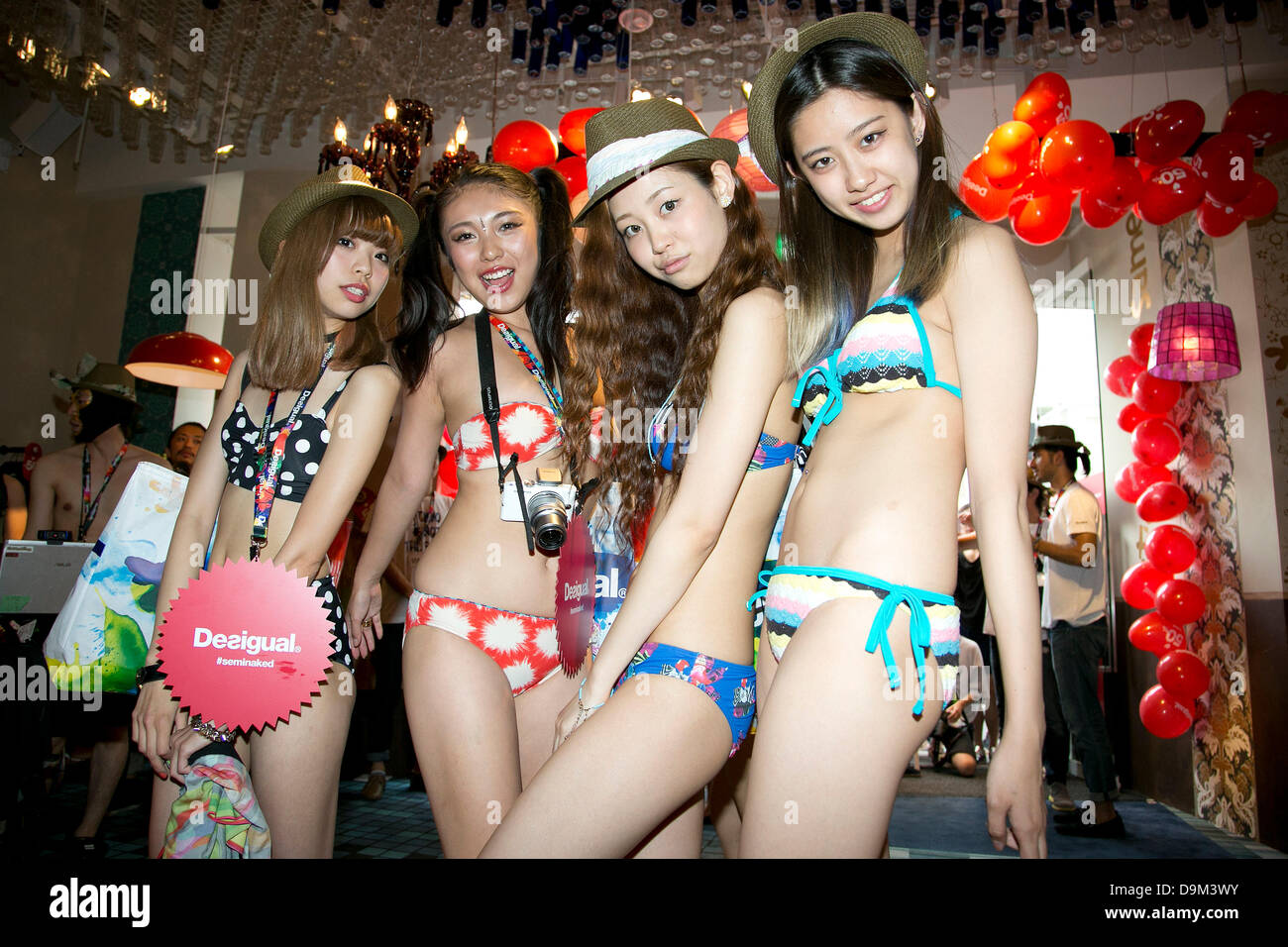 Tokyo, Japan. 22nd June 2013. Customers in swimsuit pose for cameras inside  the Desigual store in Tokyo's Harajuku fashion district. A fashion chain  called "Seminaked Party by Desigual" offers the first 100