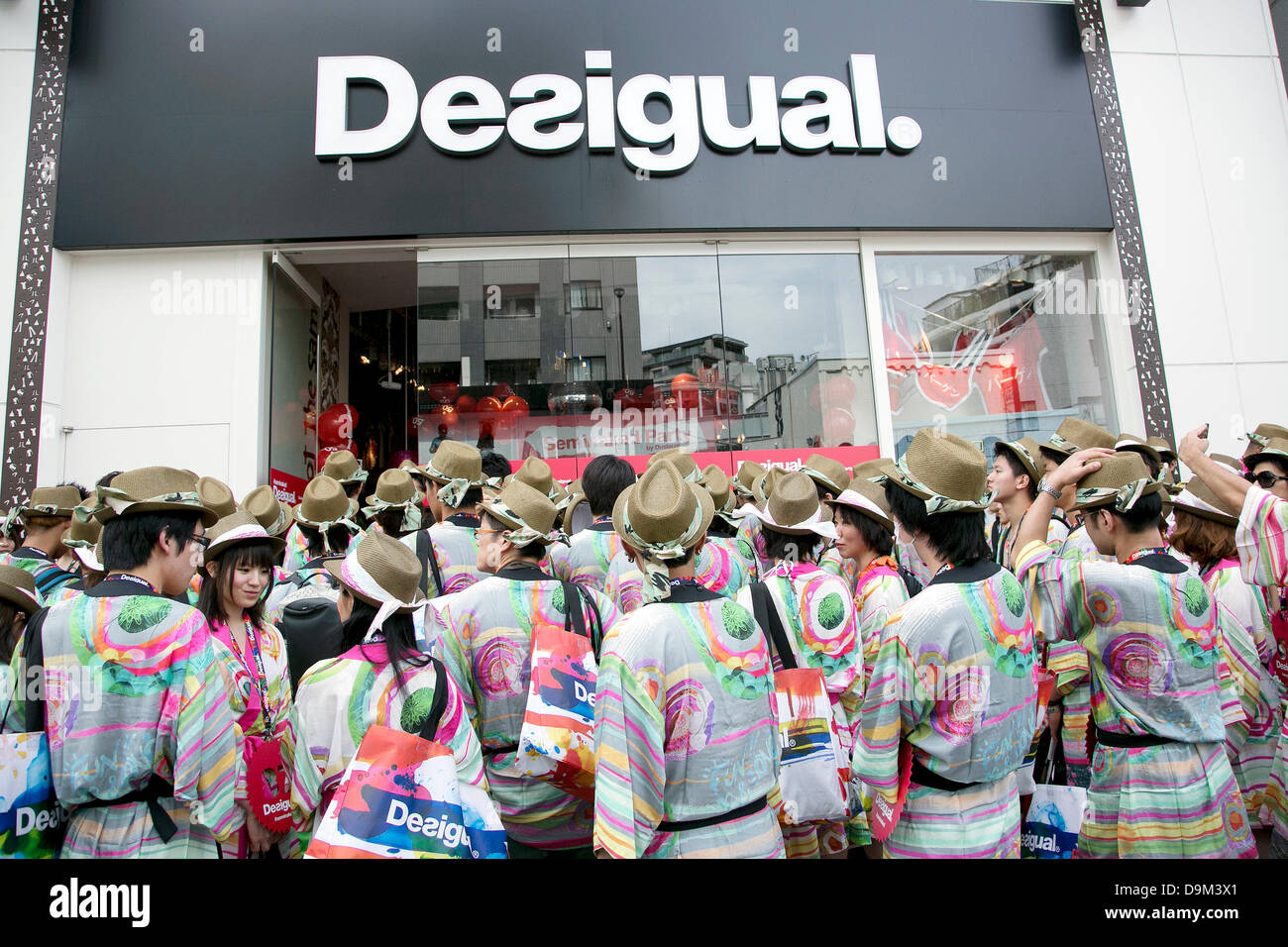 Tokyo, Japan. 22nd June 2013. Customers wait outside the Desigual store  during the grand opening in Tokyo's Harajuku fashion district. A fashion  chain called "Seminaked Party by Desigual" offers the first 100