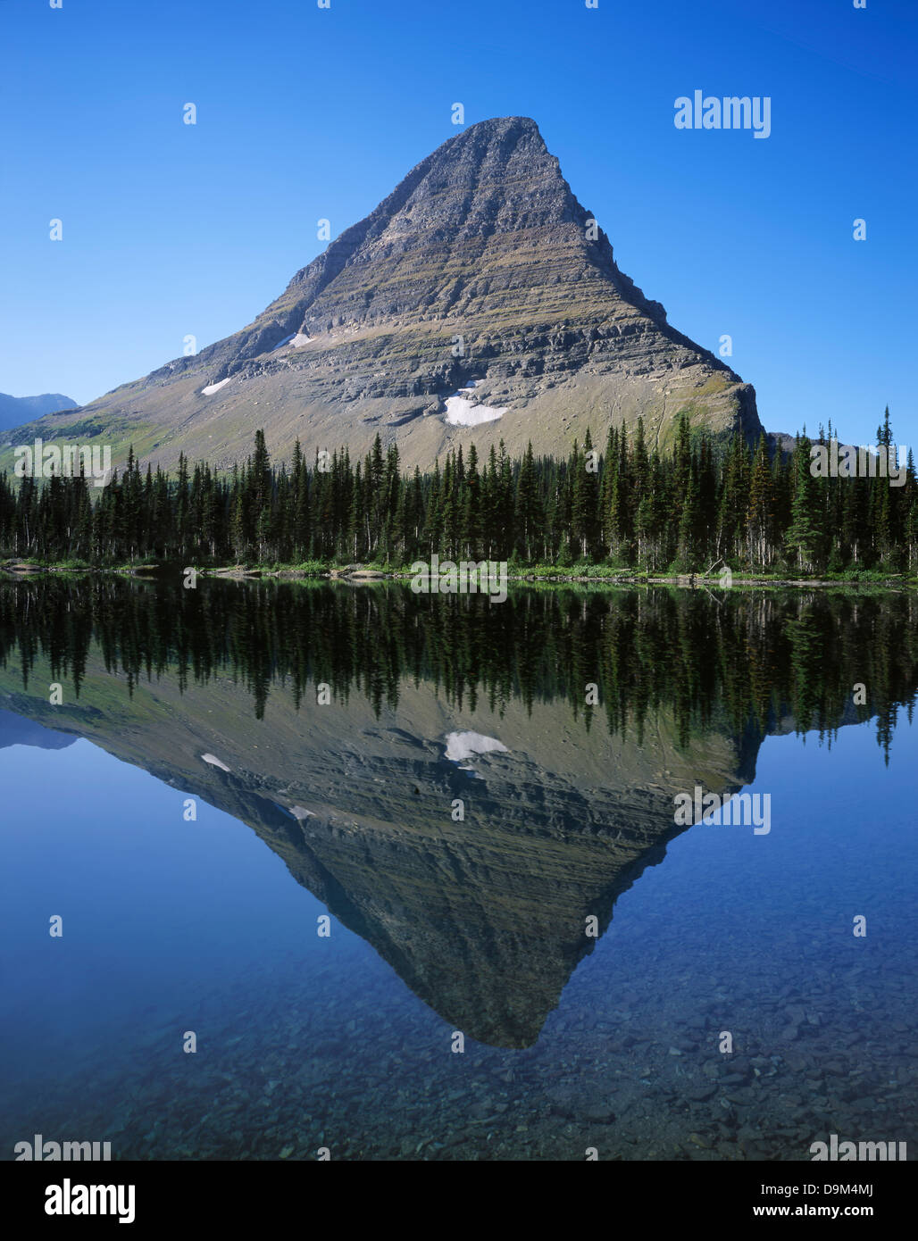 The Perfect Reflection Of A Glacially Carved Peak In A Mountain Lake At the-perfect-reflection-of-a-glacially-carved-peak-in-a-mountain-lake-at