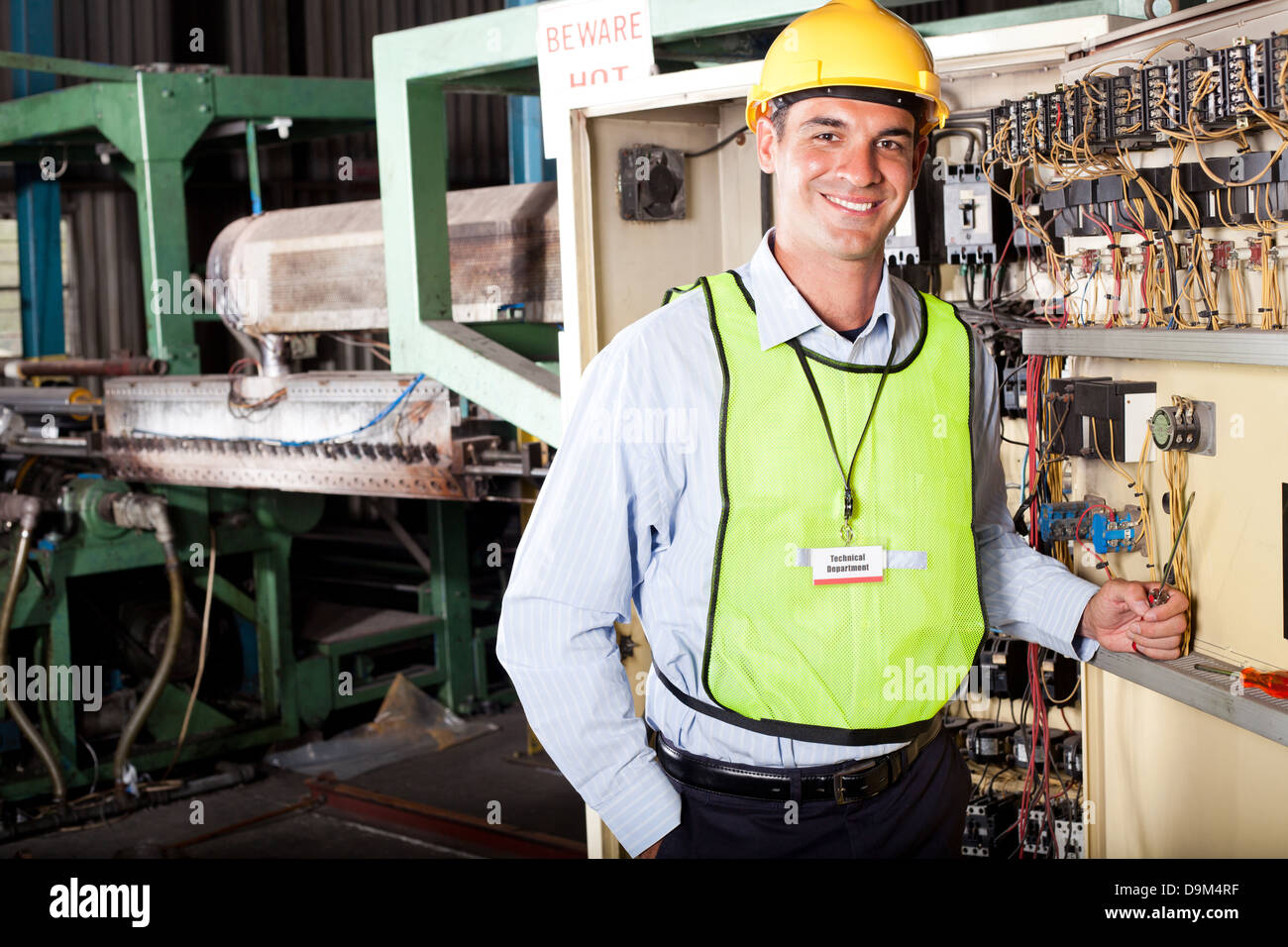 male Caucasian industrial technician portrait in front of machinery Stock Photo