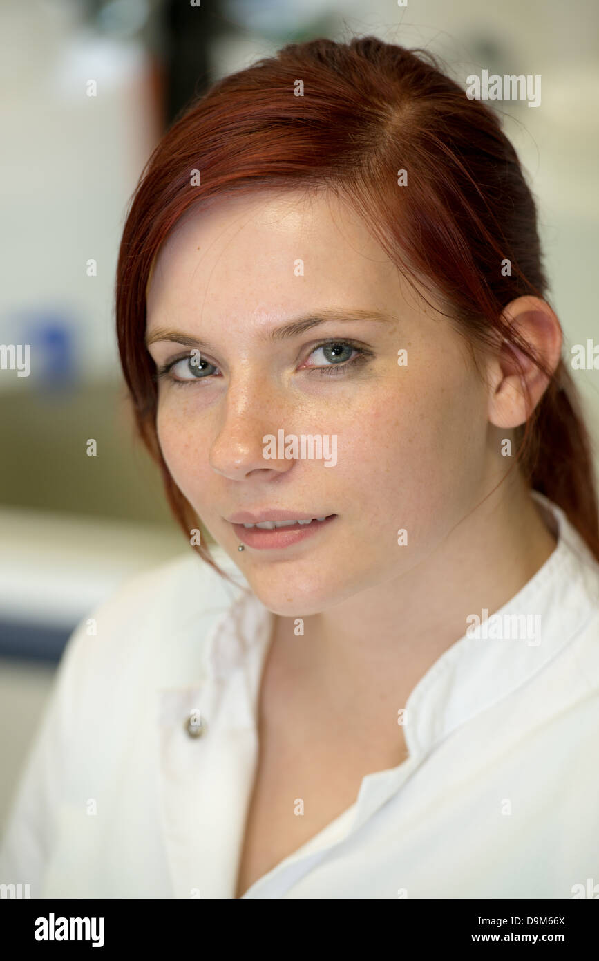 young woman with red hair looking Stock Photo