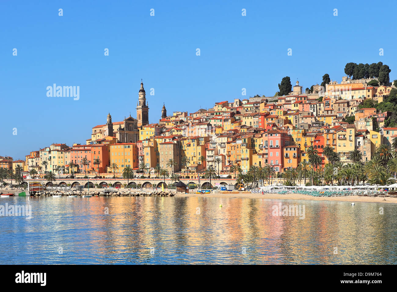 View on colorful houses of old town of Menton under blue sky on French Riviera in Southern France. Stock Photo