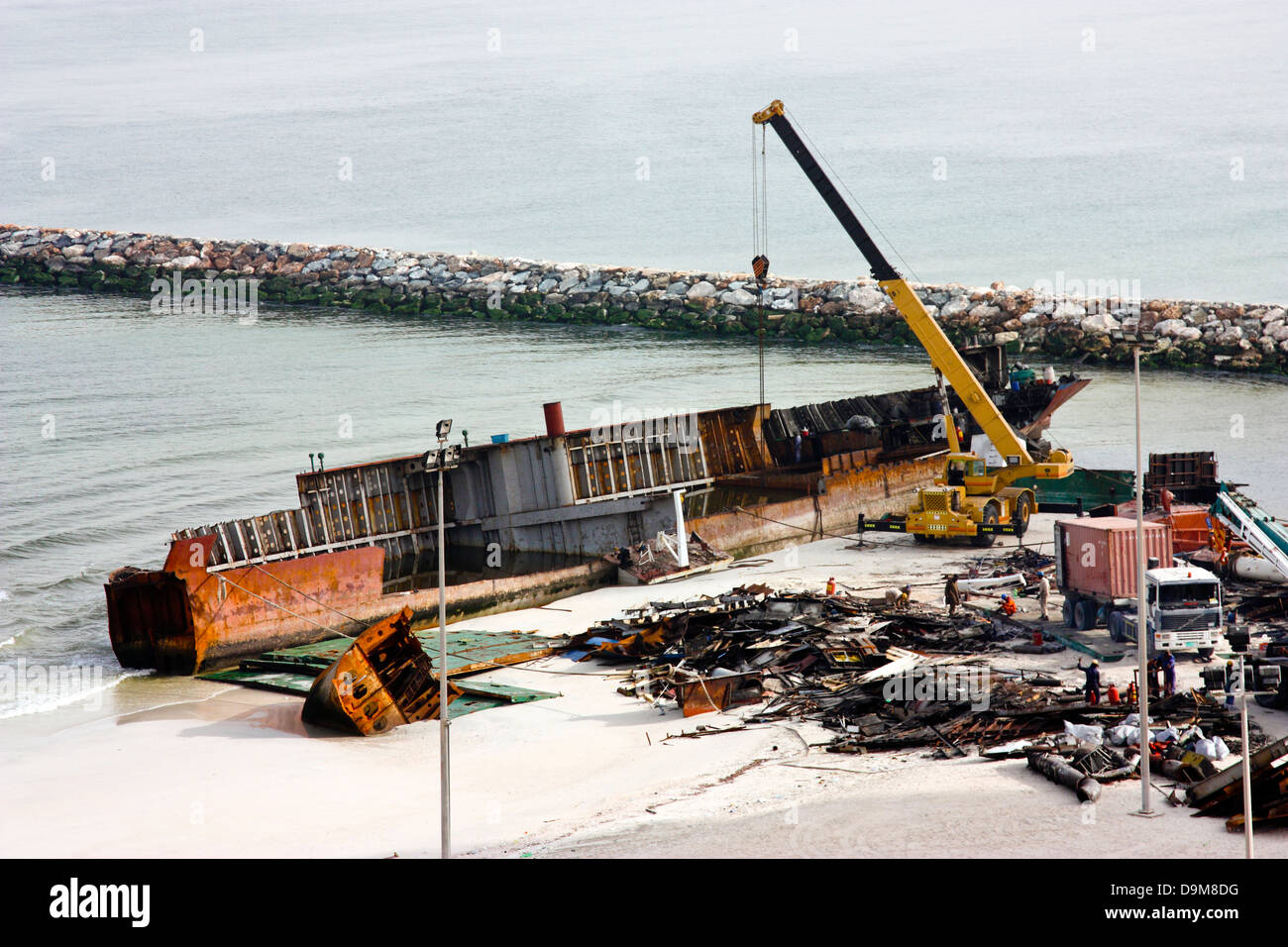 Ship breaking on the Beach, Coastal Freighter run aground in Ajman, United Arab Emirates Stock Photo