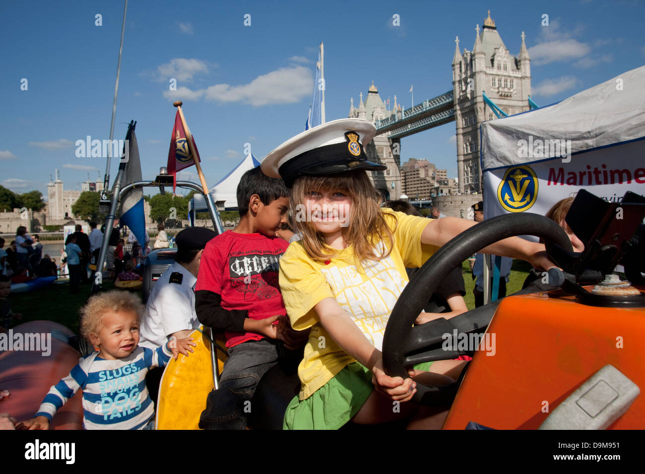 Thames Festival 2009, potters field park. Children trying out a small lifeboat. Stock Photo