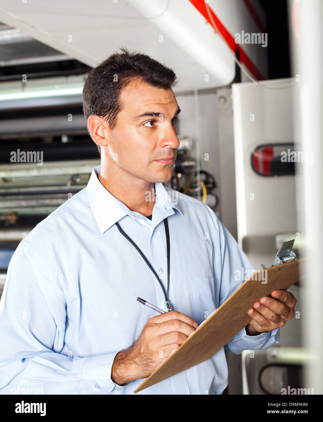 industrial technician taking machine readings Stock Photo