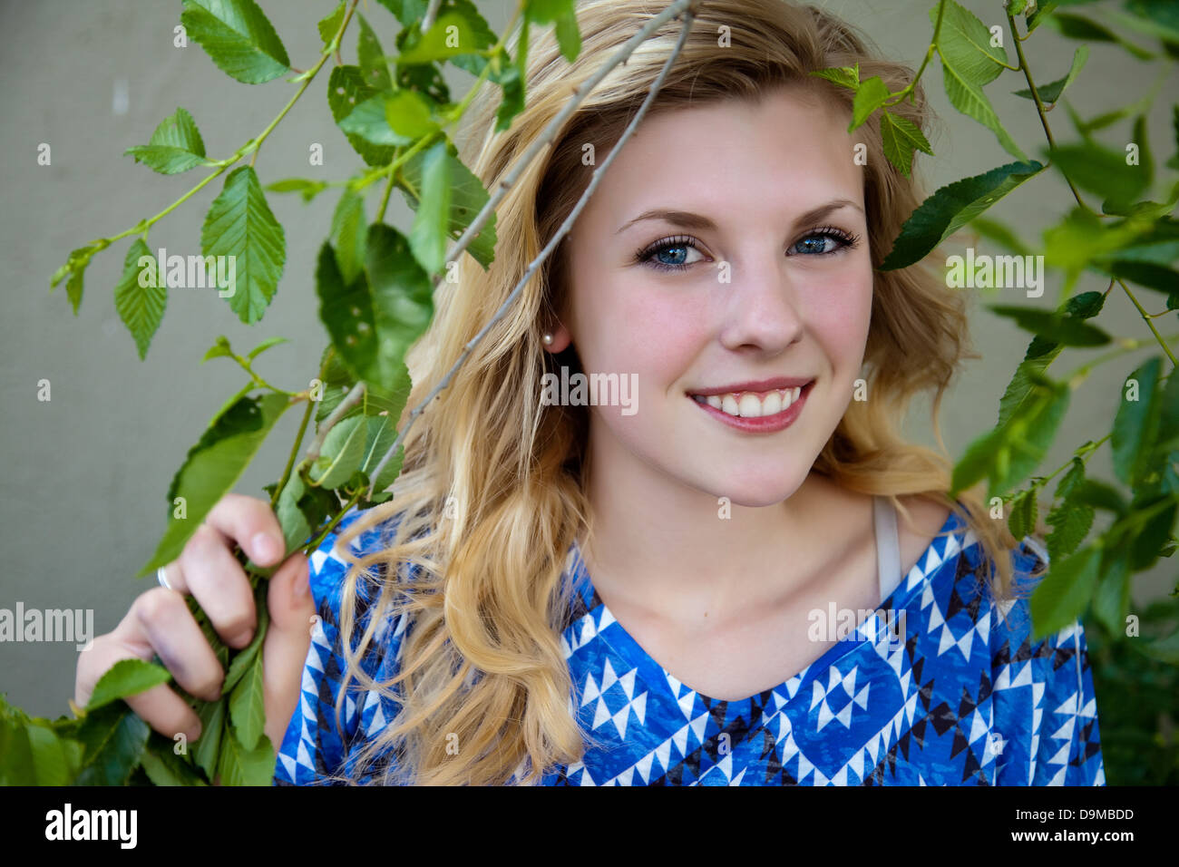 Outdoor photo of young, pretty, blond girl in foliage Stock Photo