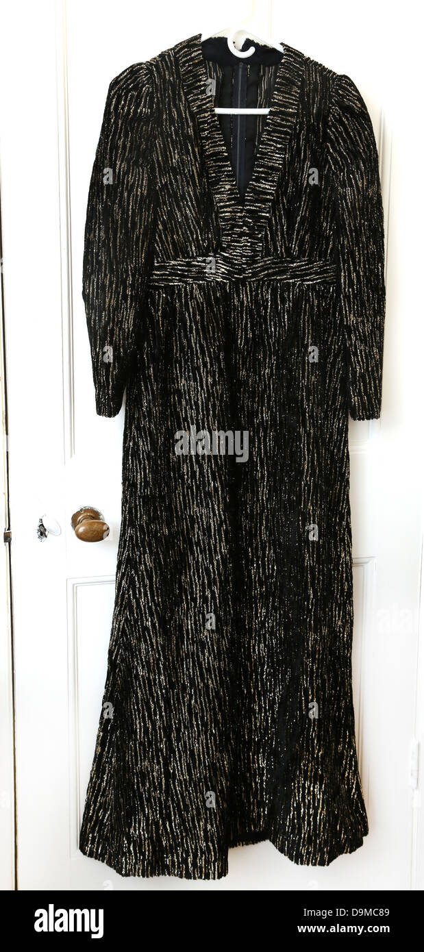 Black With Gold Thread Dress Hanging On Door Stock Photo - Alamy