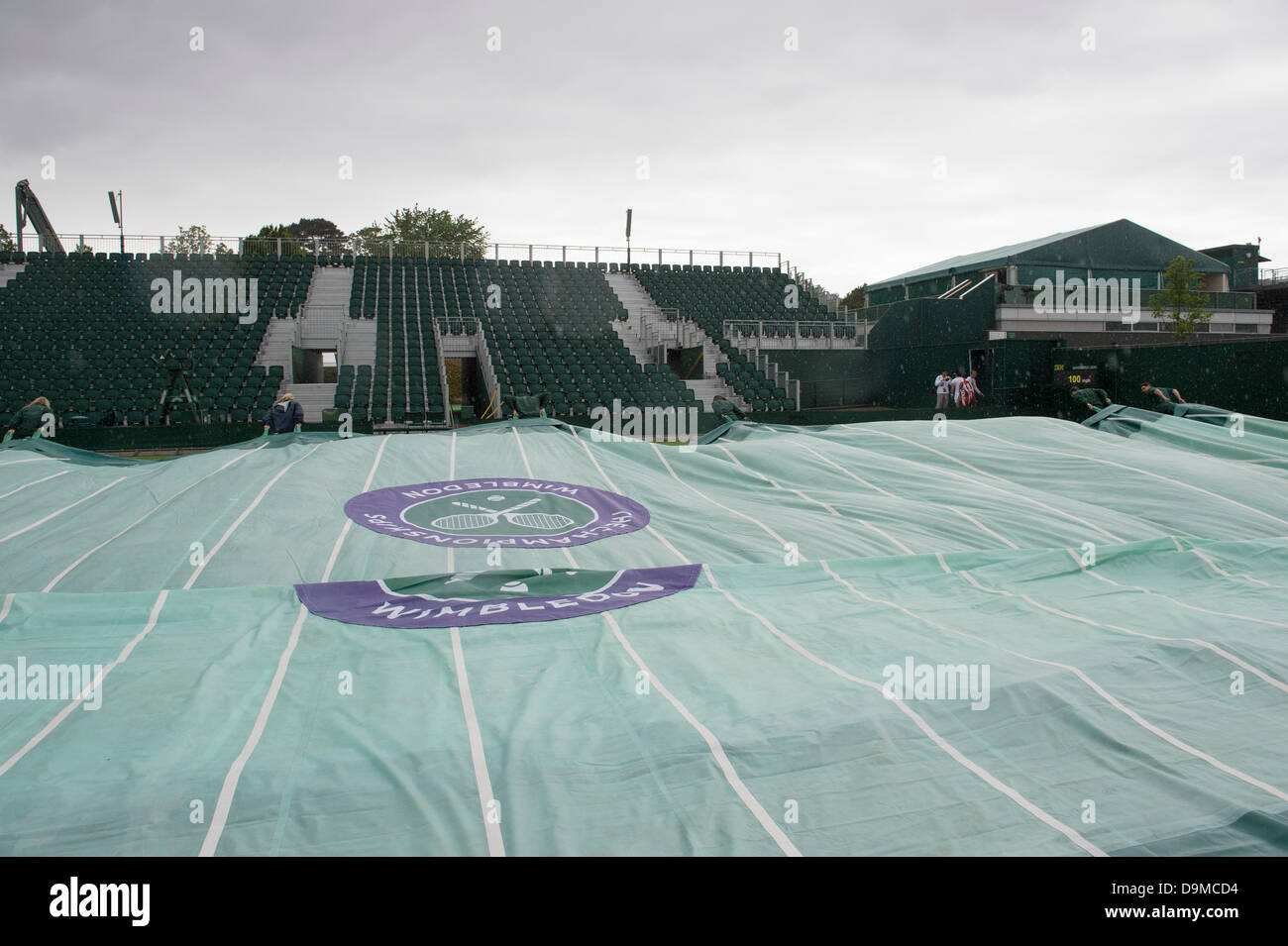 London, UK. 22nd June 2013. Practice and preparations take place ahead of The Wimbledon Tennis Championships 2013 held at The All England Lawn Tennis and Croquet Club.  General View (GV).  Rain stops practice at Wimbledon. Credit:  Duncan Grove/Alamy Live News Stock Photo