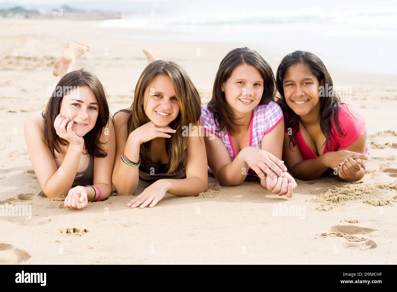 group of teen girls lying on beach Stock Photo Alamy