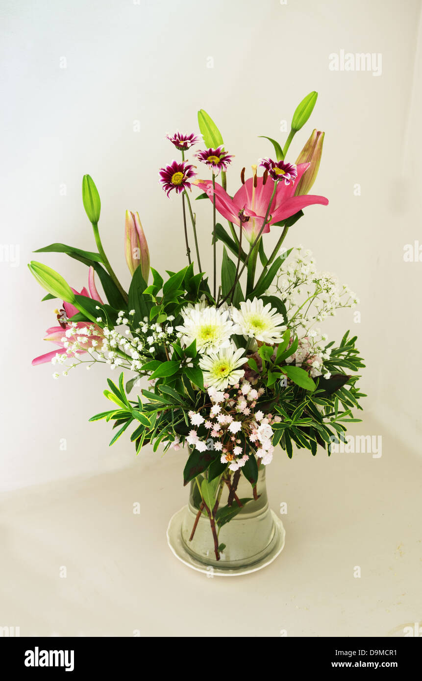 spring flower bouquet arrangement with lily daisy and laurel flowers Stock Photo
