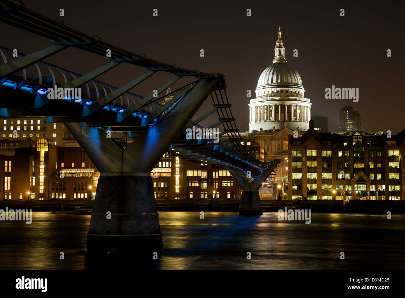 Night time. Millennium bridge crossing the River Thames to St Paul's Cathedral. London England UK Stock Photo